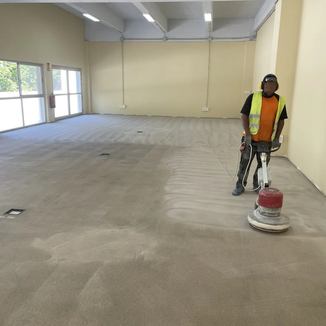 A worker with a floor grinder A worker with a floor grinder