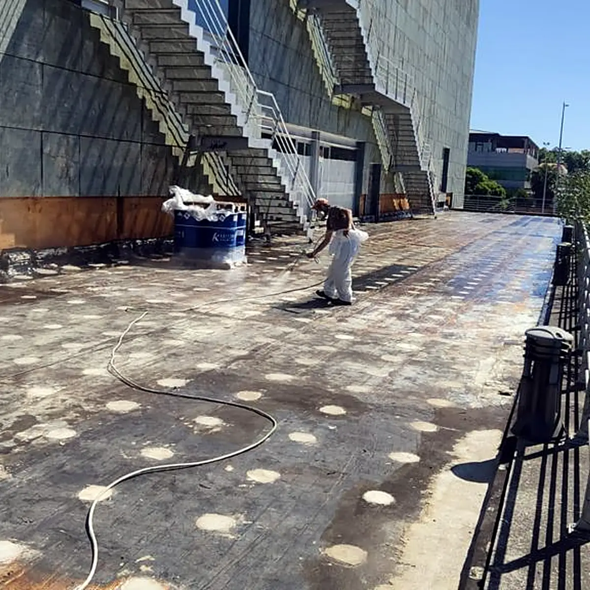 Long terrace beside a steel stair with the grey coat going on Long terrace beside a steel stair with the grey coat going on