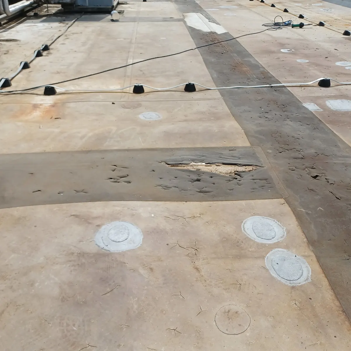 Close detail of patched roof substrate before spray, Milan
