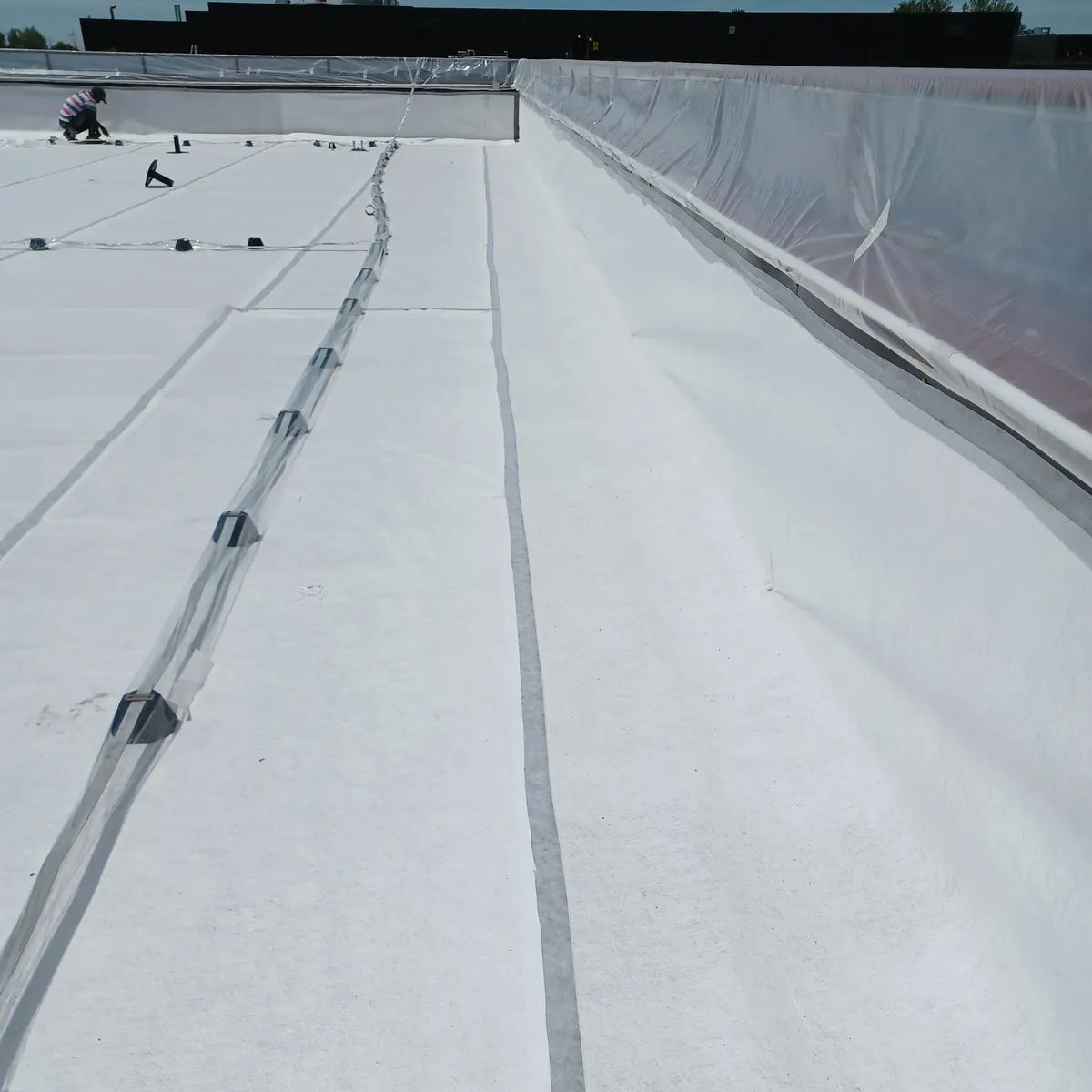 Long white waterproofed aisle on Mediolanum roof, Milan