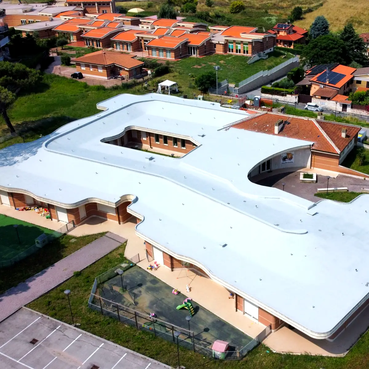 Aerial view of the Amalia Gamboni nursery roof among homes in Rome