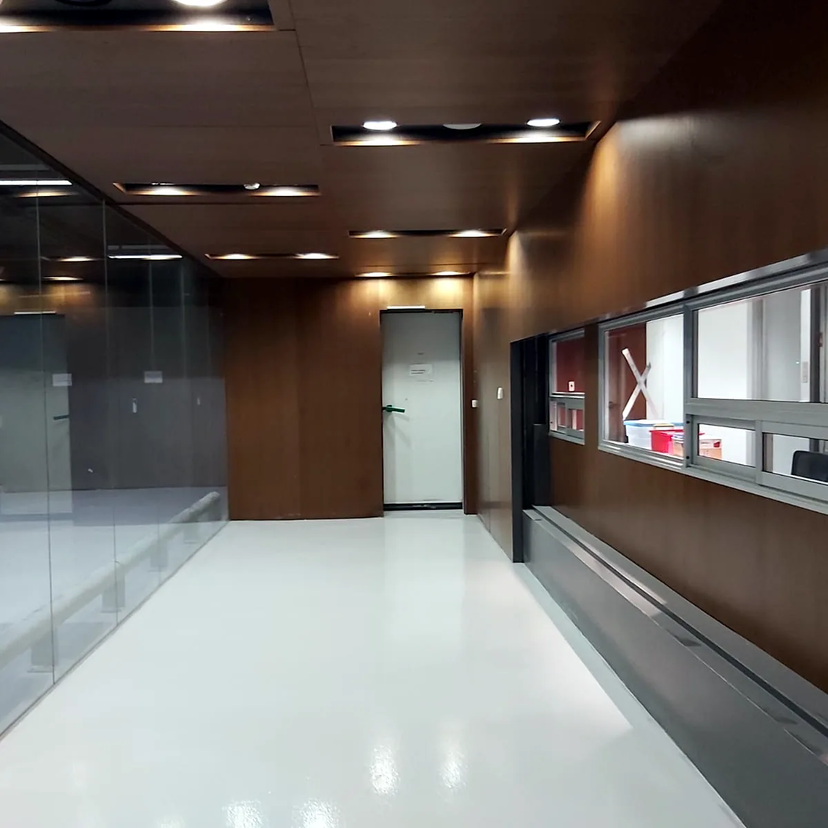 Coated corridor floor by a wood-panelled wall