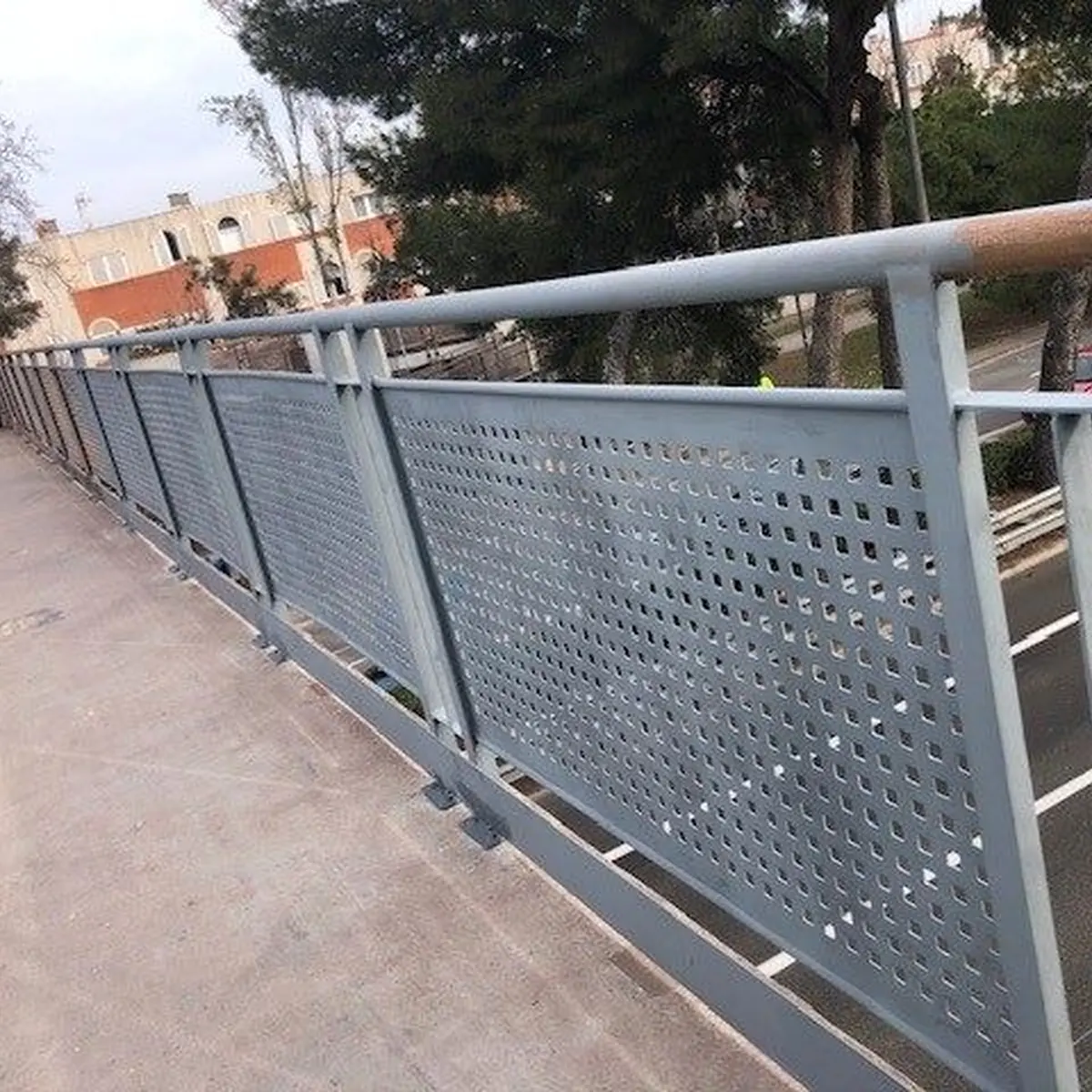 Bridge walkway with perforated steel railing panels, Castelldefels
