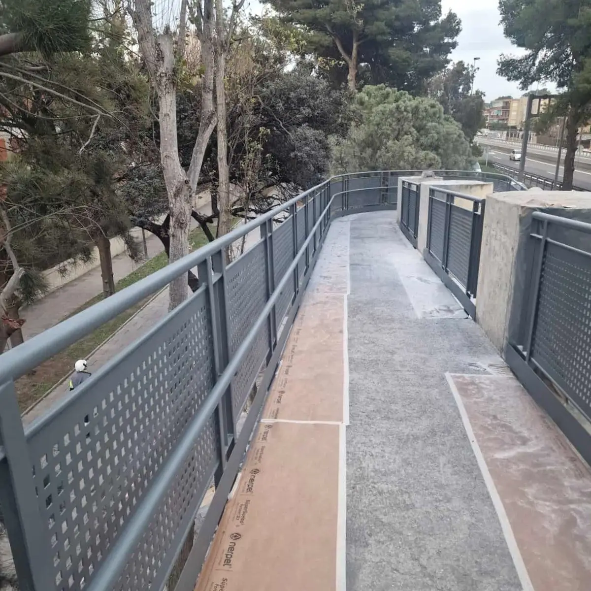 Wide view of the coated ramp railings among the pines, Castelldefels