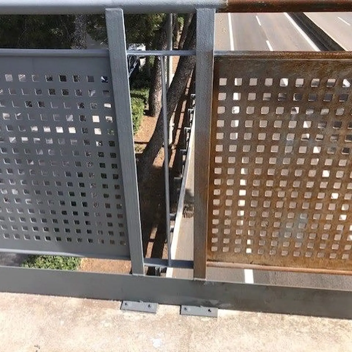 Rusted perforated railing panel beside a coated one, Castelldefels