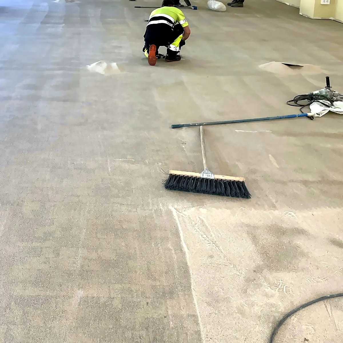 Swept concrete substrate and broom ready for the primer, Badajoz