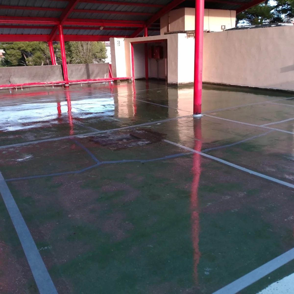 Freshly coated parking bays under red steel canopies, Mallorca