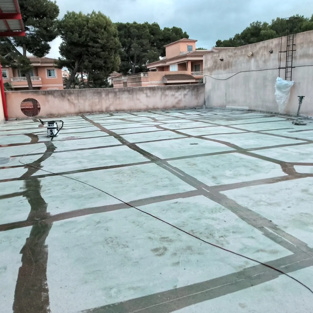 Wide view of sealed cracks across the open car park roof, Mallorca