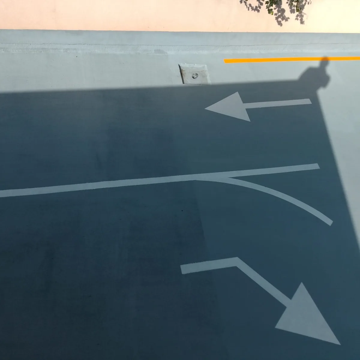Curved arrows on the coated ramp in shade, Mallorca