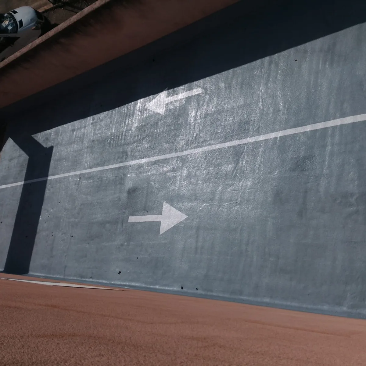 Coated ramp meeting the side wall with an arrow marking, Mallorca