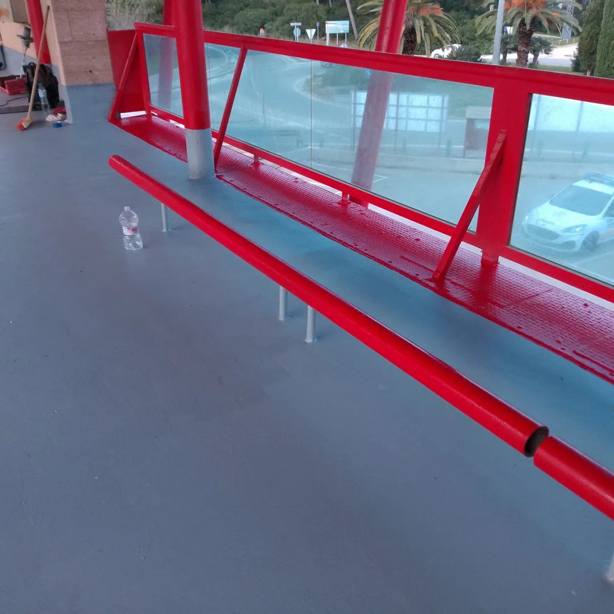 Coated deck edge beside a red guard railing, Santa Margarida