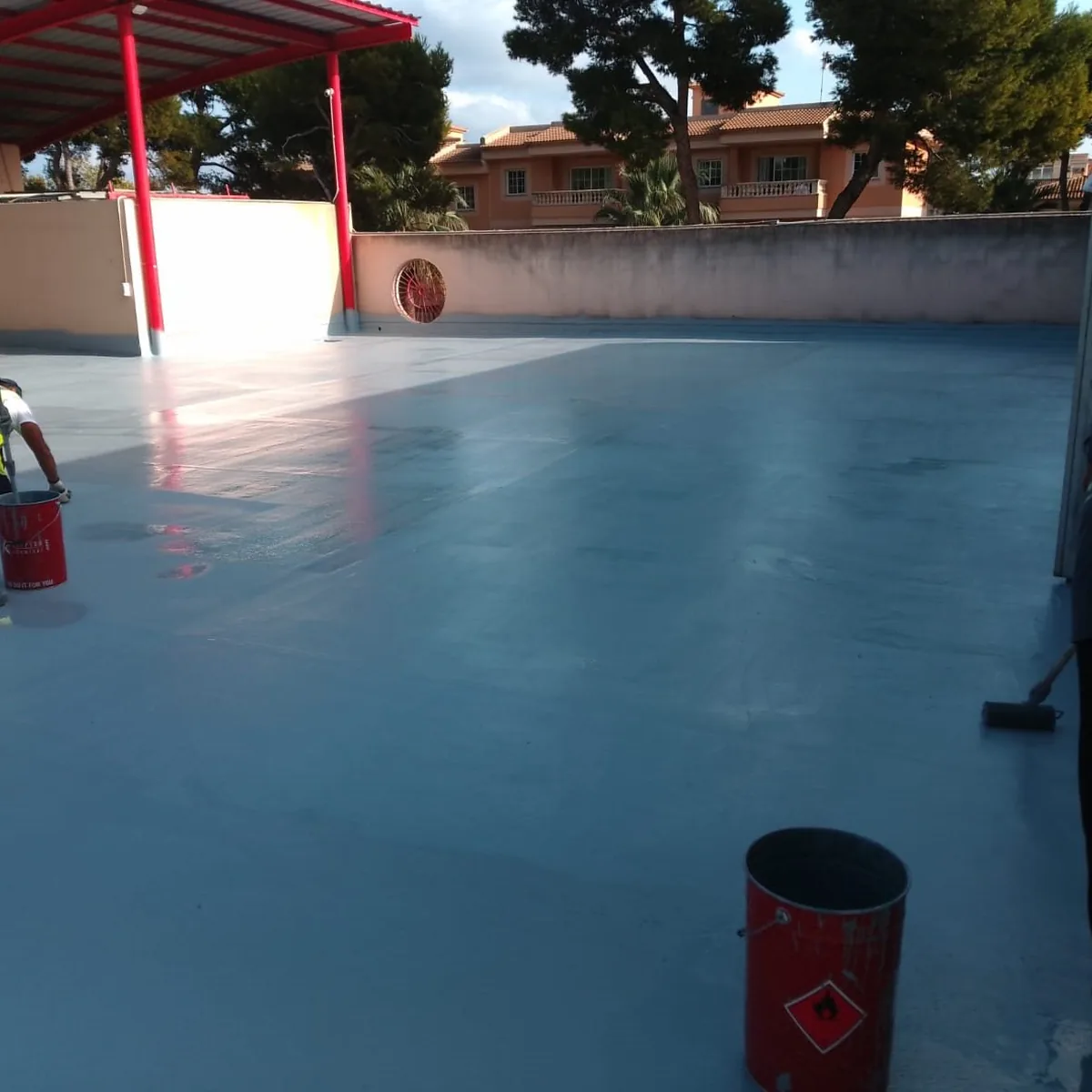 Crew at work on the parking roof during membrane application, Mallorca