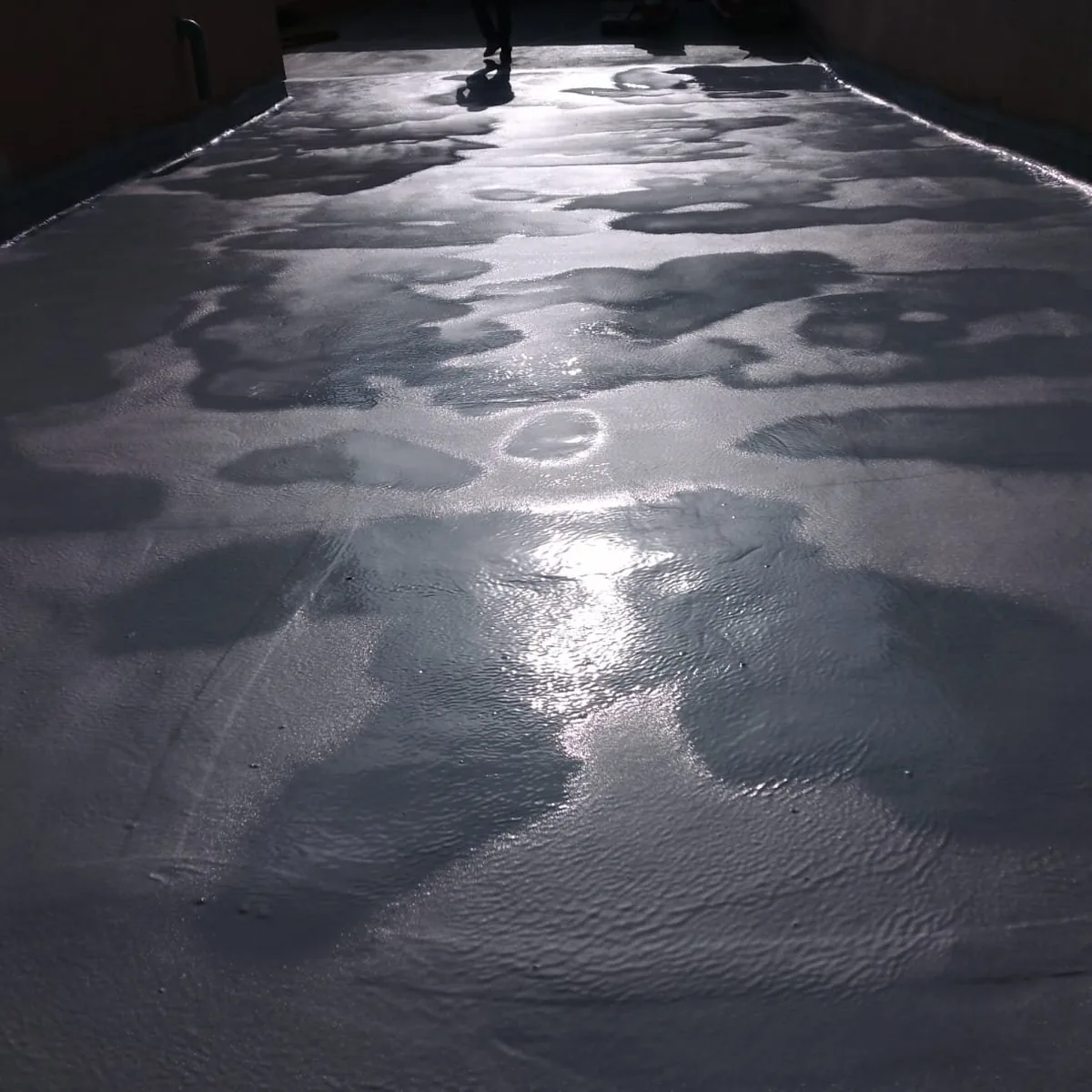 Wet, worn car park roof deck before repair, Mallorca
