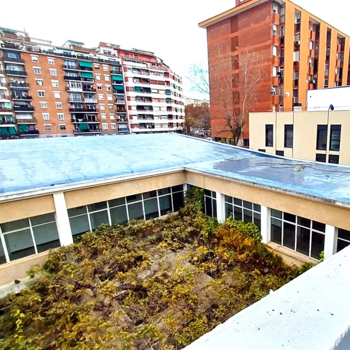 Roofline of the cultural centre around its green courtyard, Barcelona