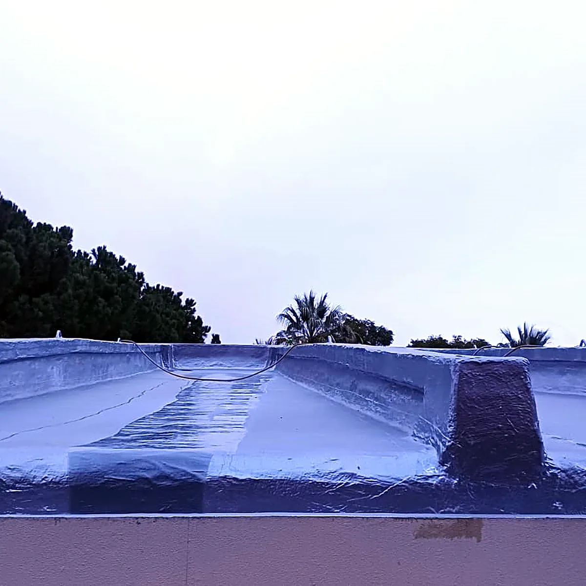 Membrane over a raised roof ridge under an overcast sky, Barcelona