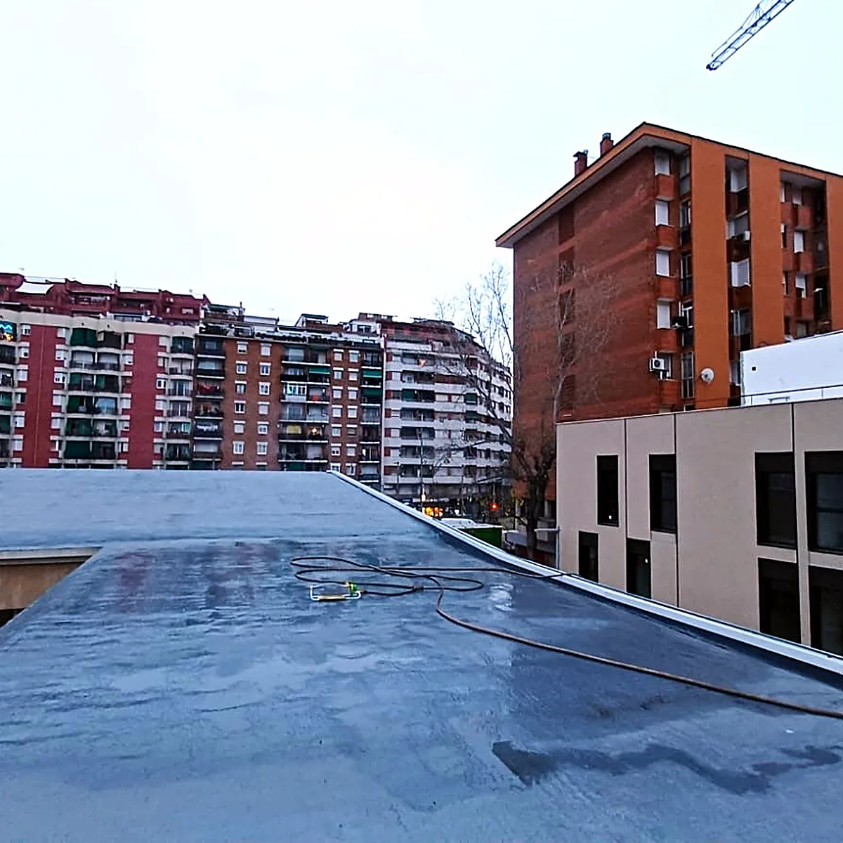 Finished cultural centre roof with apartment blocks behind, Sants