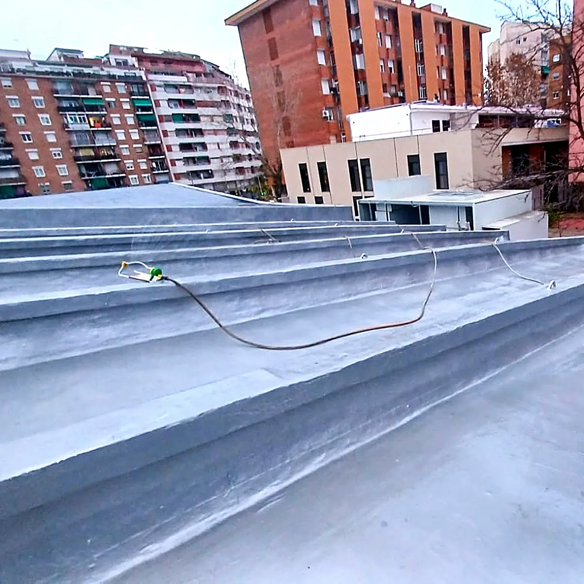 Stepped roof levels covered in the aluminium polyurea membrane, Barcelona
