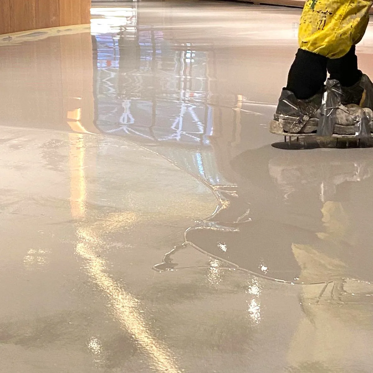 Glossy decorative floor with a worker in safety boots, Salou