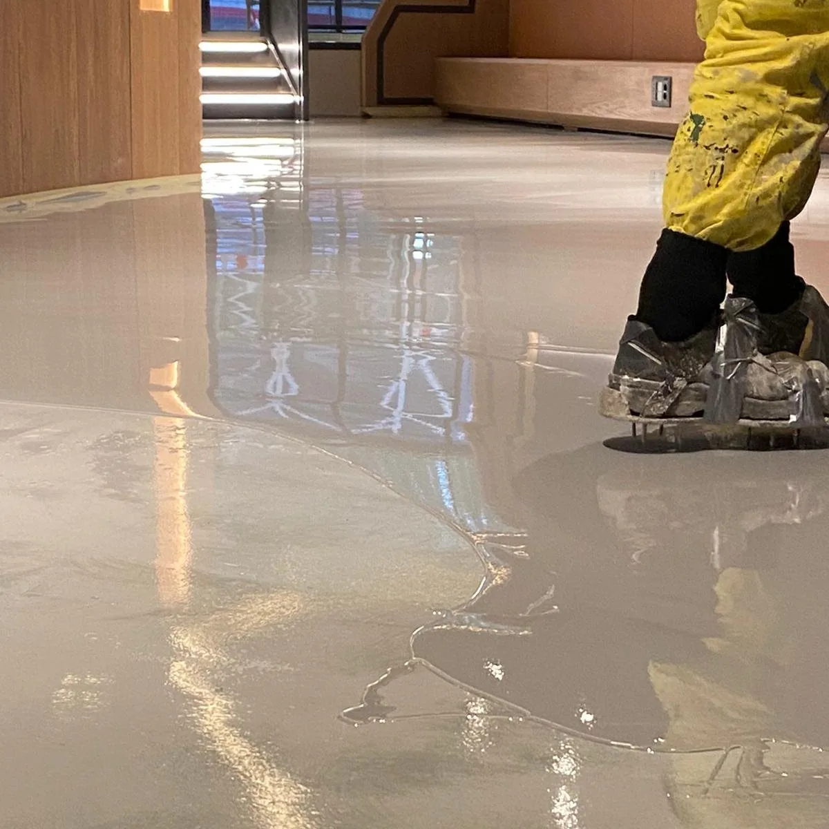 Glossy decorative floor with a worker in a hi-vis jacket, Salou