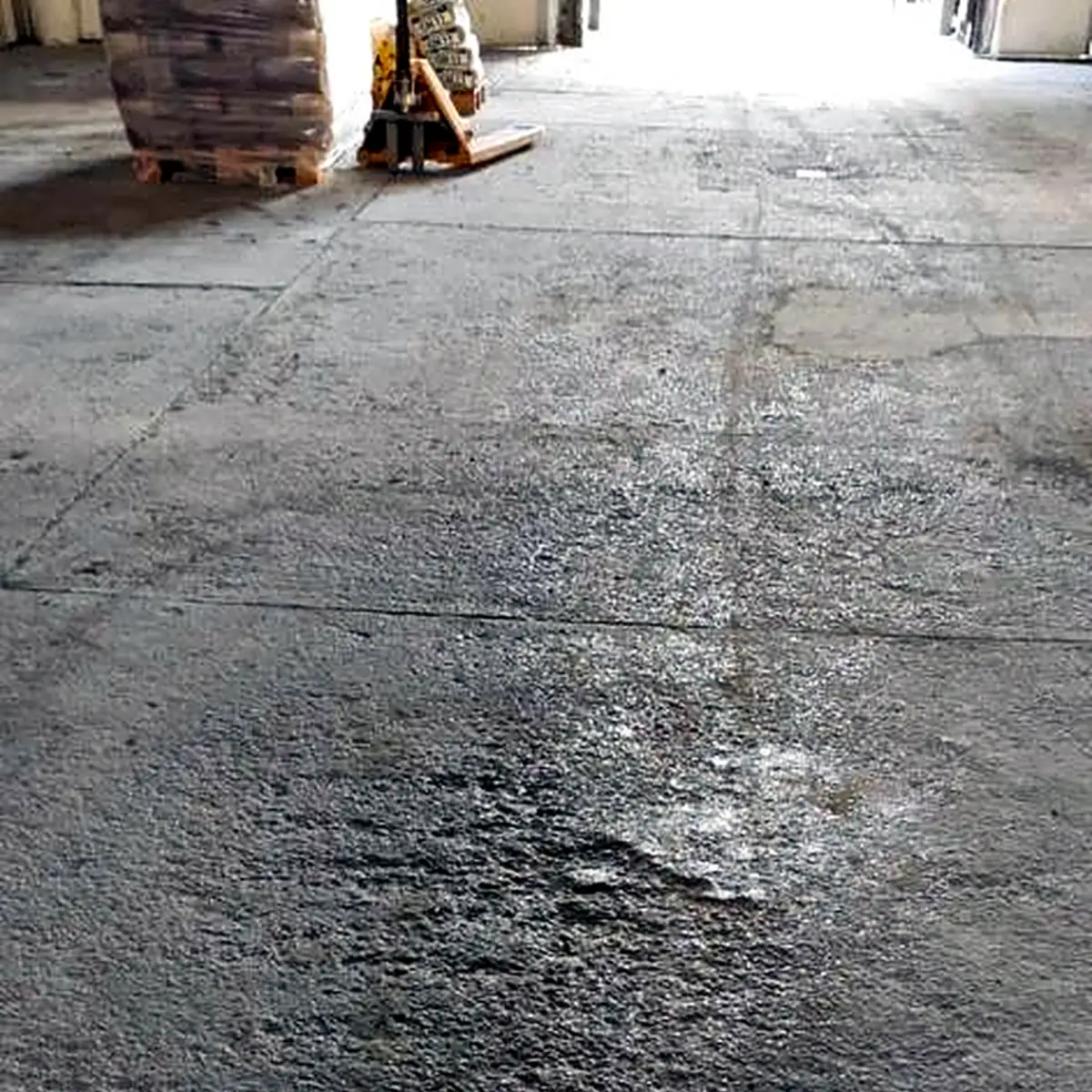 Cracked and worn concrete slab before the works, warehouse in Ukraine