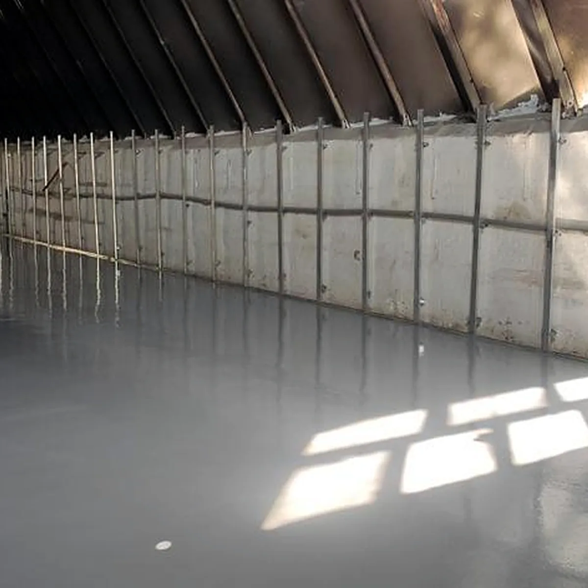 Long view of the coated warehouse floor and timber roof