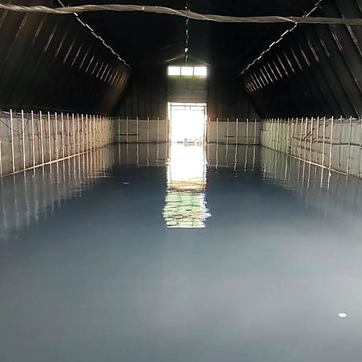 Wide view of the new grey floor under the timber roof, Ukraine