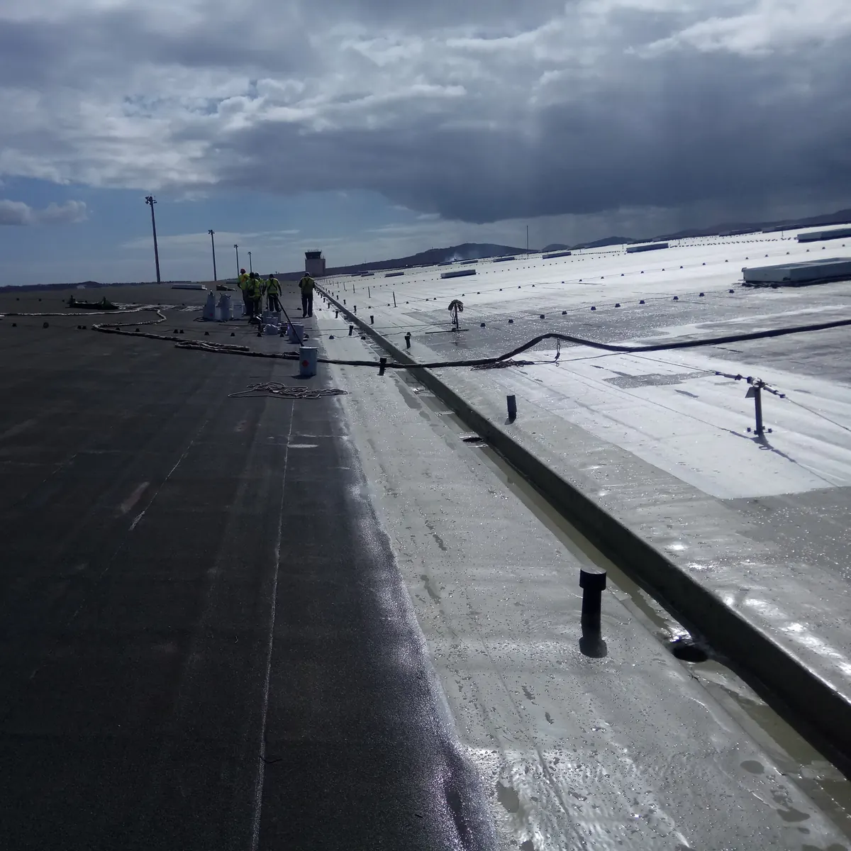 New wet coat beside the area still open, with the control tower in the distance