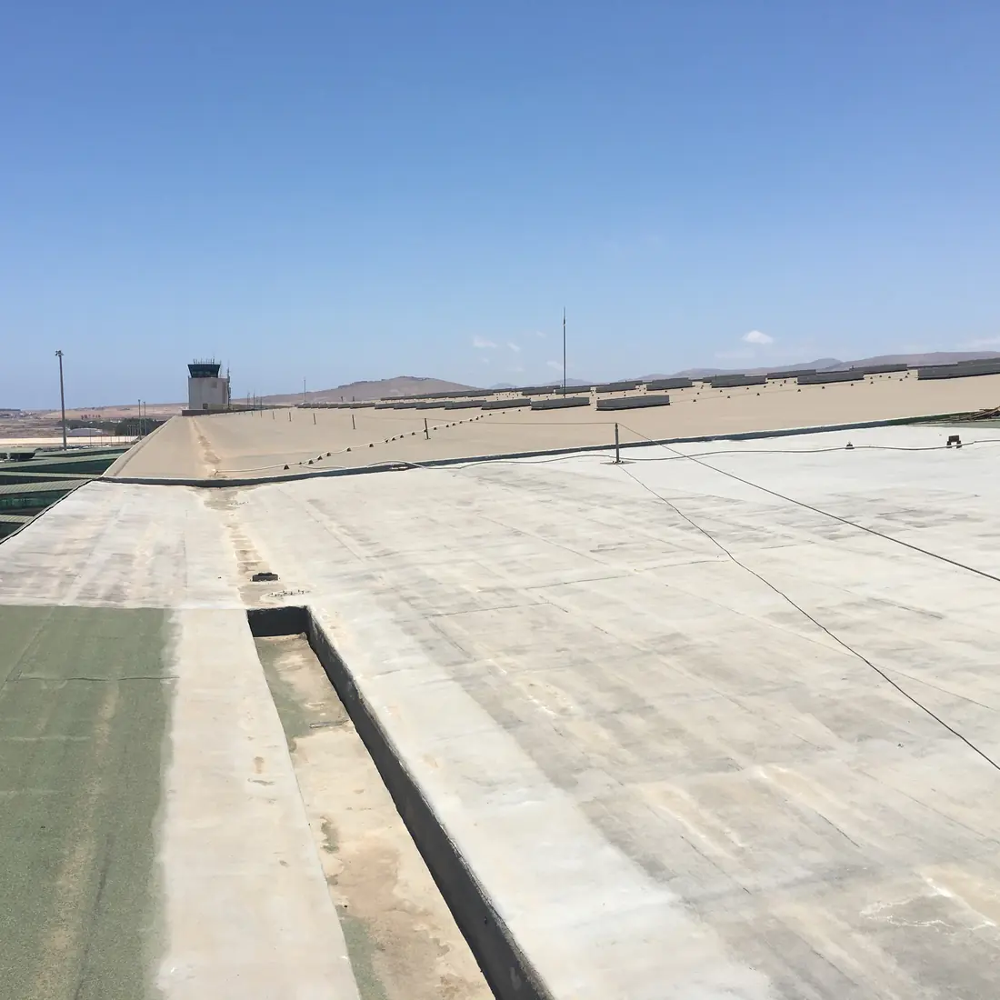 Channel between the green membrane and a pale roof area