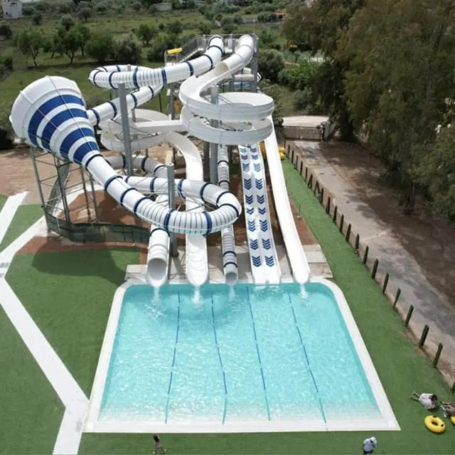 Blue and white slides over the splash pool at a water park in Greece Blue and white slides over the splash pool at a water park in Greece