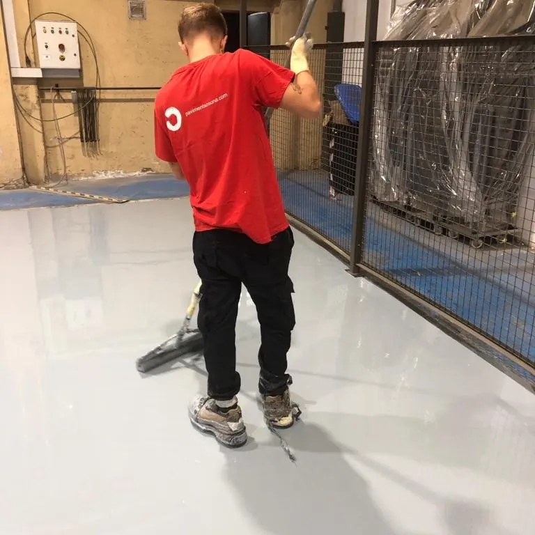 A worker on the grey workshop floor A worker on the grey workshop floor