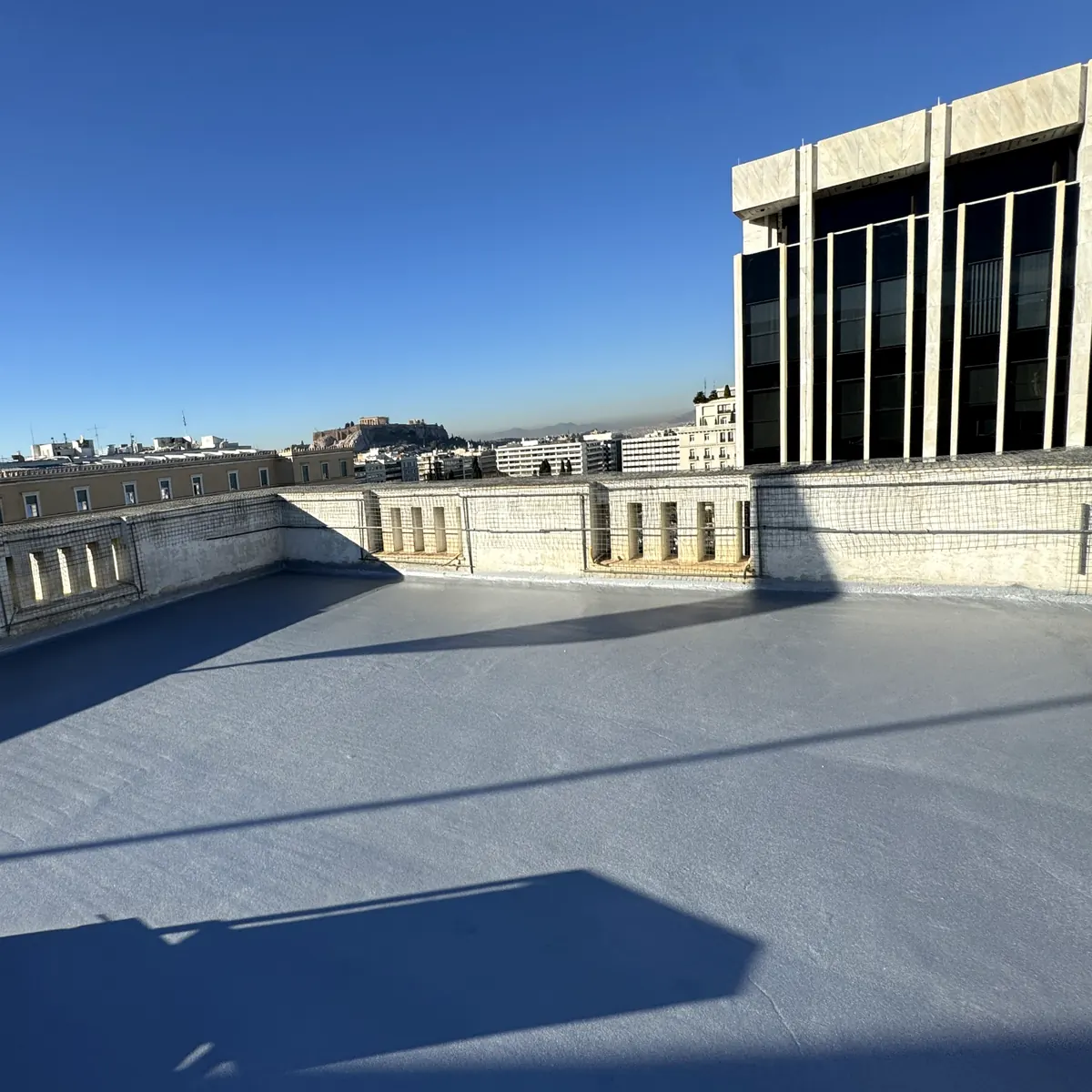 Wide embassy roof waterproofing field overlooking Athens