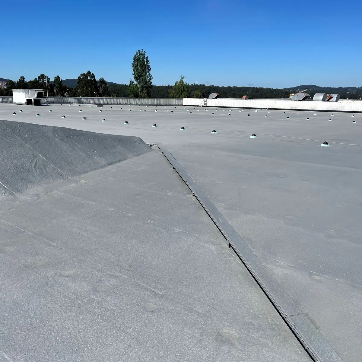 Grey membrane meeting at a roof valley, Ferrara Plaza Grey membrane meeting at a roof valley, Ferrara Plaza