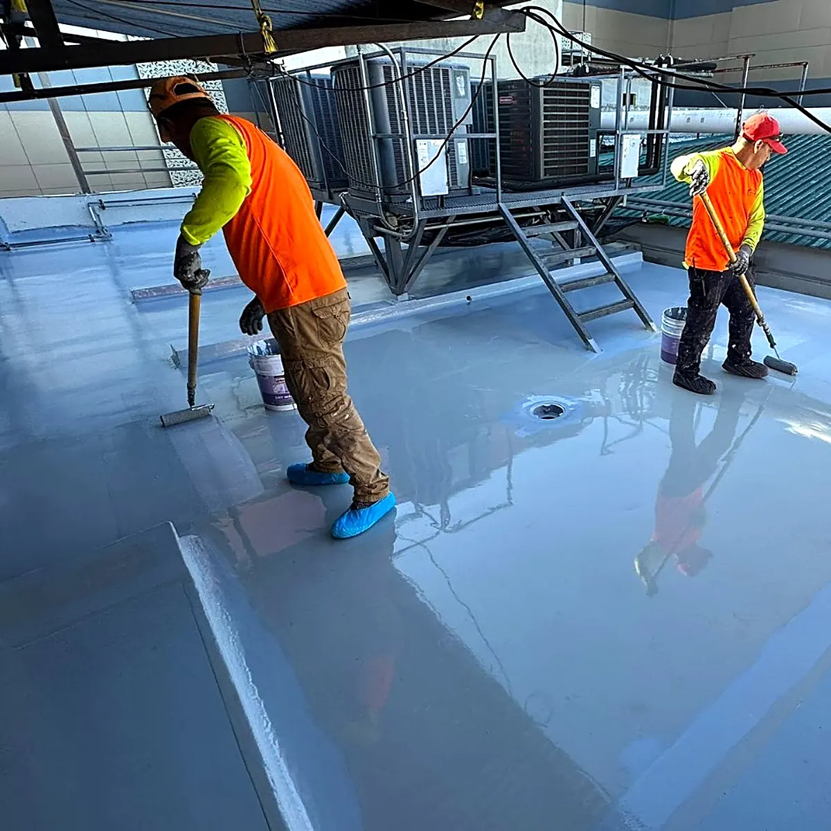 Crew at work on the east tower roof, with the plant units behind Crew at work on the east tower roof, with the plant units behind