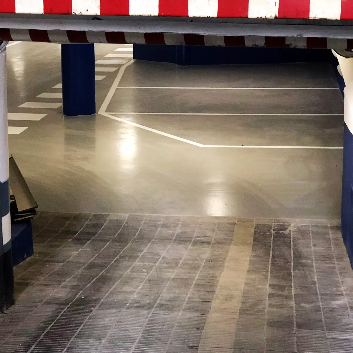 Car park entrance under the red and white height bar, hotel car park in Barcelona Car park entrance under the red and white height bar, hotel car park in Barcelona