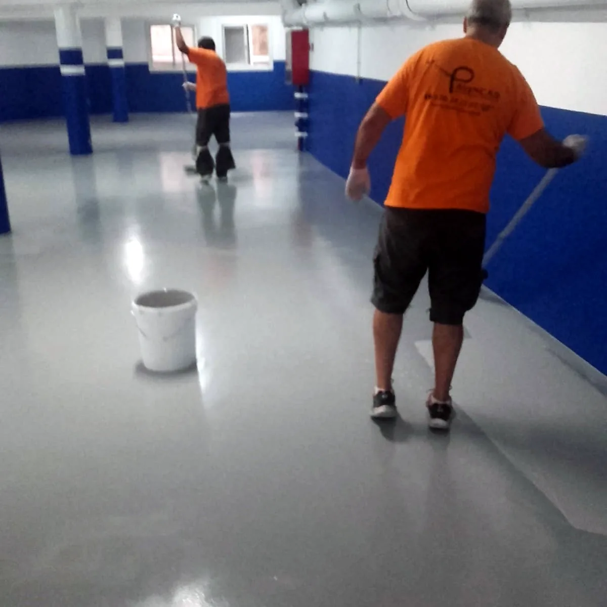 Crew applying the hotel garage epoxy coating in Barcelona toward the far end of the aisle Crew applying the hotel garage epoxy coating in Barcelona toward the far end of the aisle