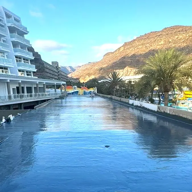 A long pool channel between the hotel and the cliff A long pool channel between the hotel and the cliff