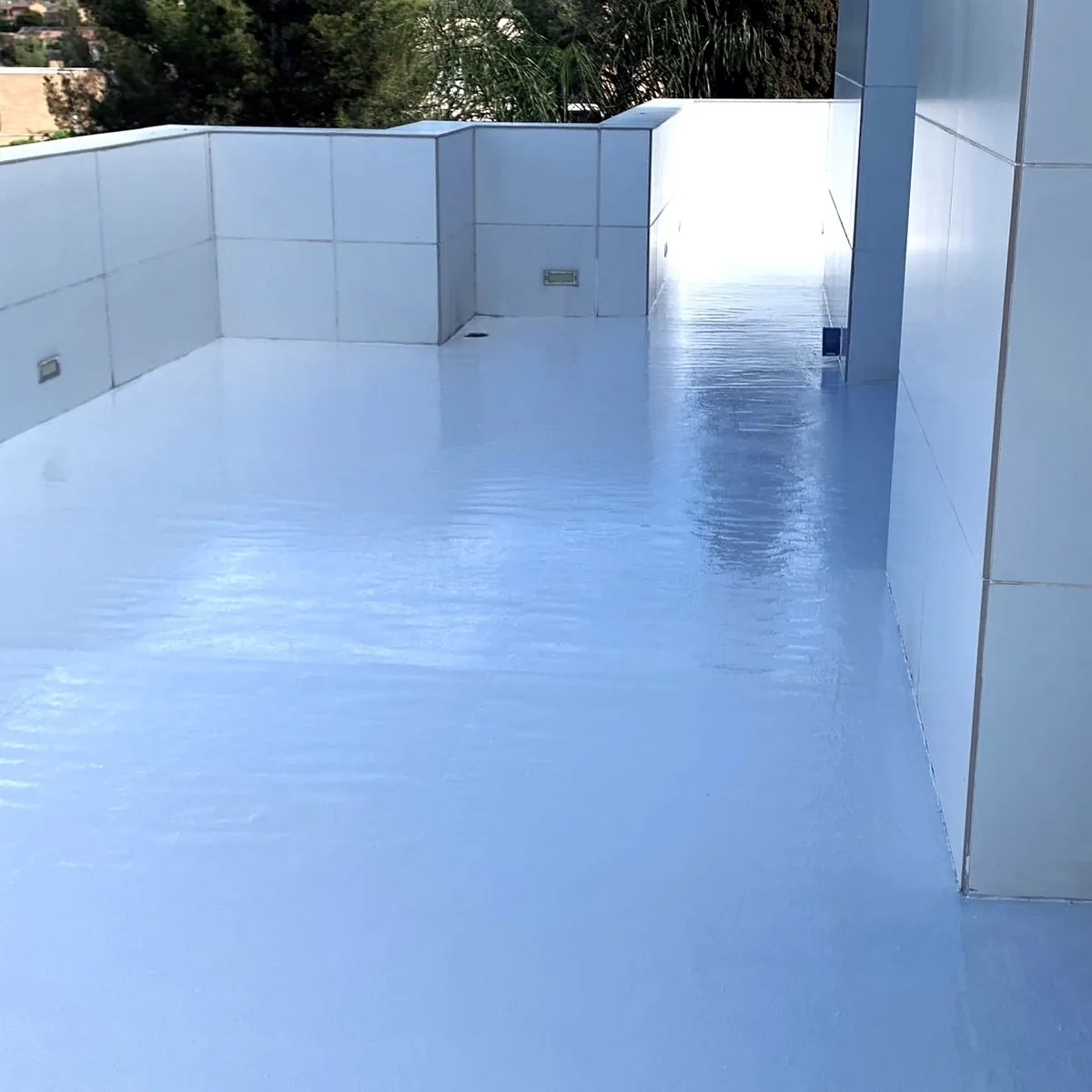 Glossy light grey strip of roof between two tiled walls, Tarragona house
