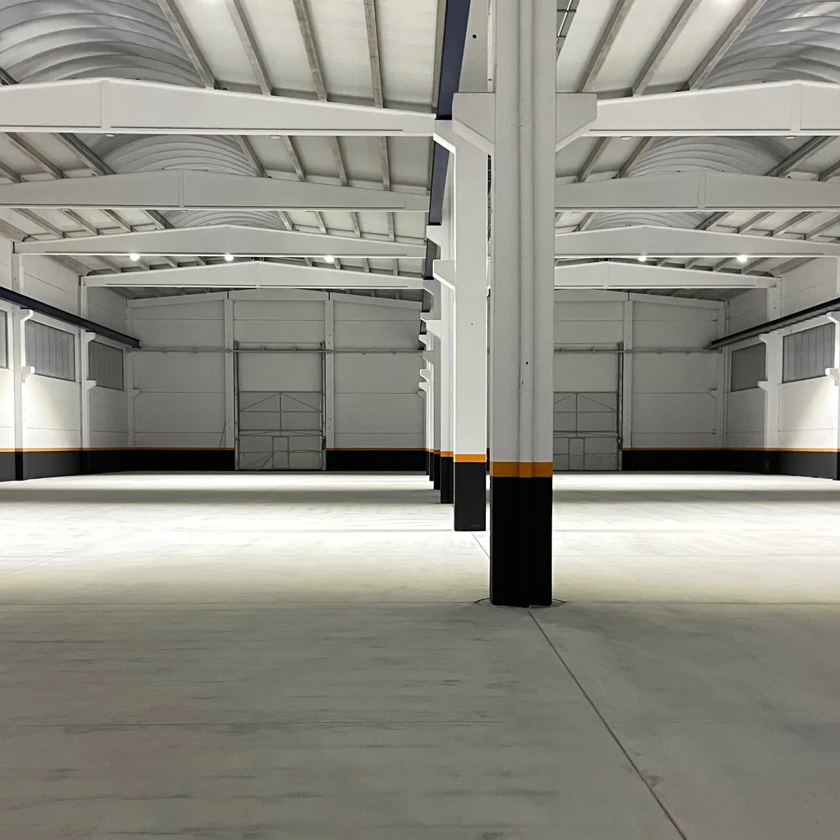 Bare concrete slab in an empty machinery factory hall before the epoxy floor, A Coruña Bare concrete slab in an empty machinery factory hall before the epoxy floor, A Coruña