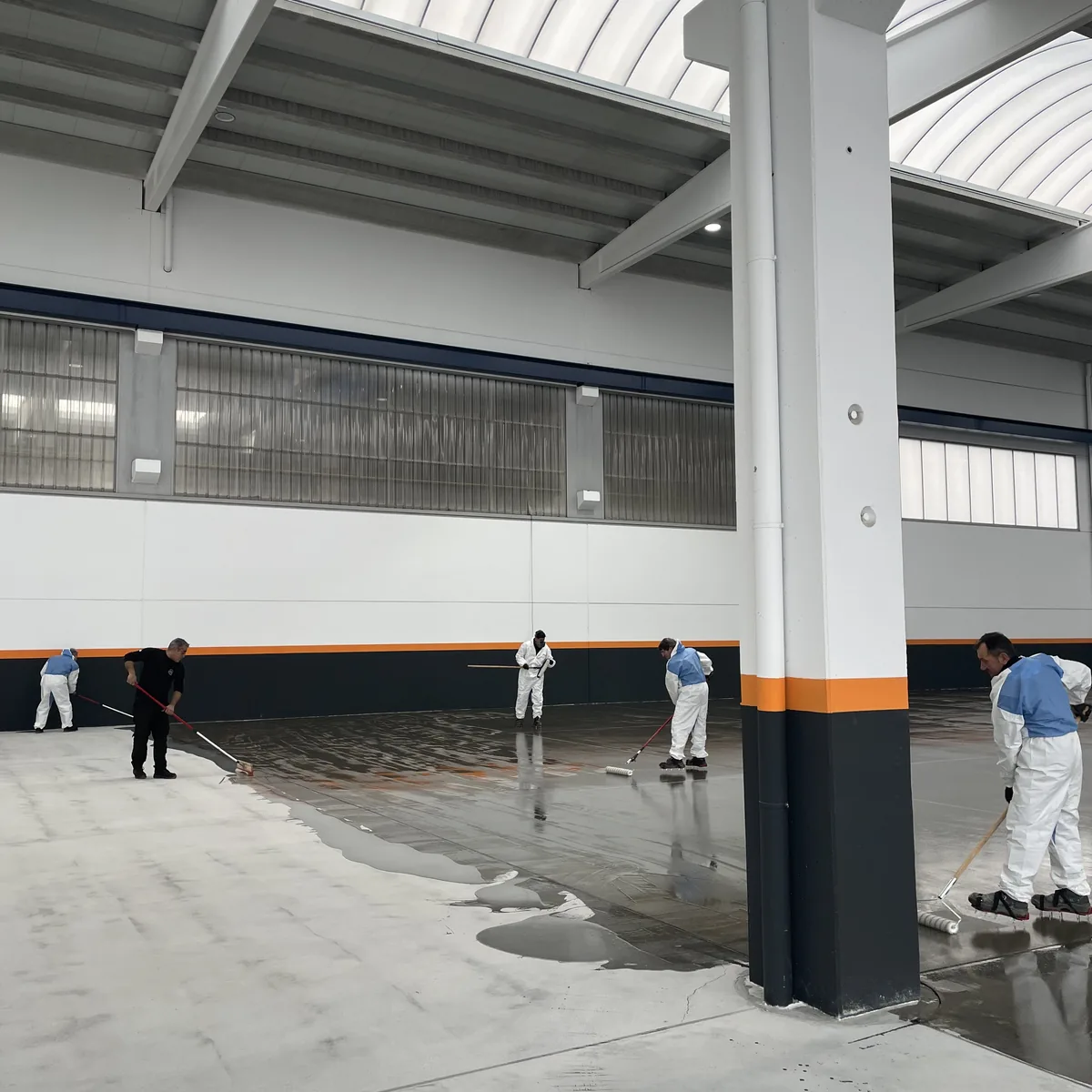 Crew mid-way through the grey epoxy coat beside a column, Galicia Crew mid-way through the grey epoxy coat beside a column, Galicia