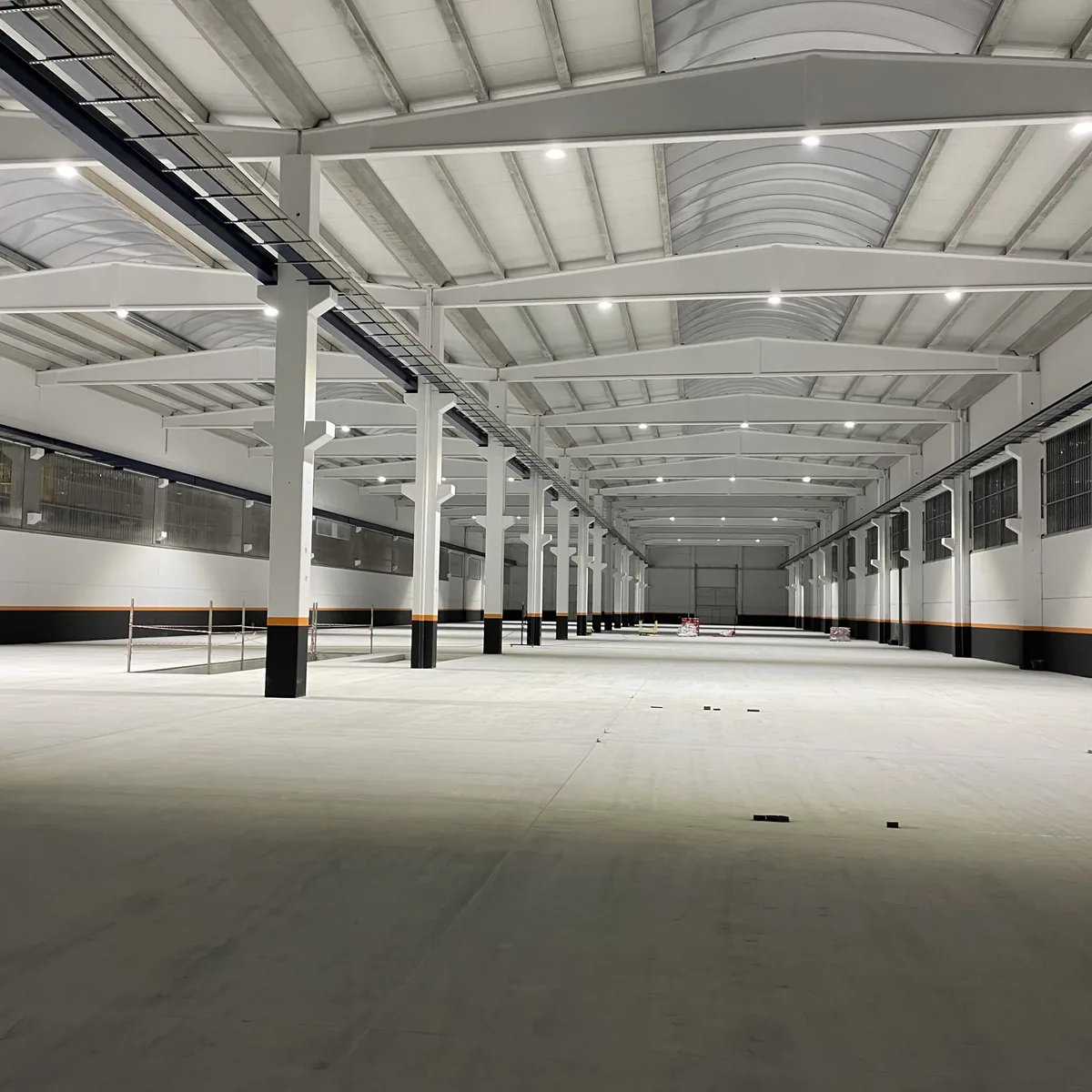 Perspective of an empty factory bay before the epoxy floor, Galicia Perspective of an empty factory bay before the epoxy floor, Galicia