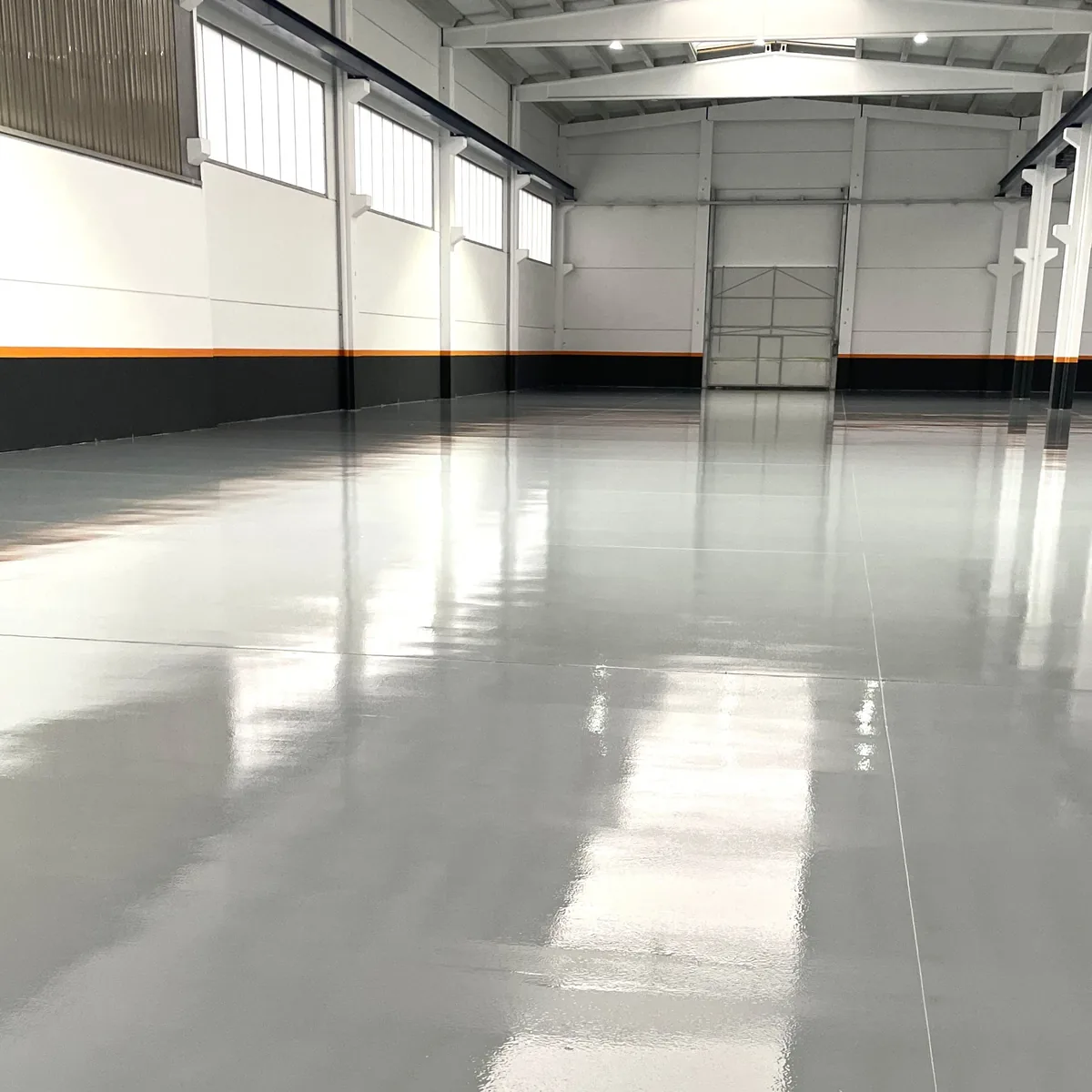 Finished grey epoxy factory floor leading to the loading door, Galicia Finished grey epoxy factory floor leading to the loading door, Galicia
