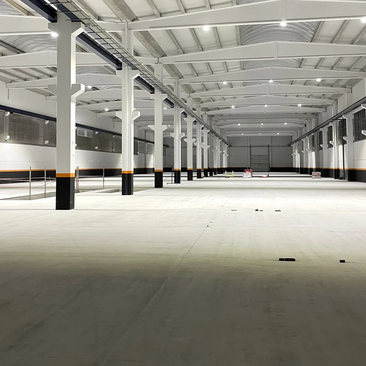 Long factory bay with bare concrete and steel columns before epoxy coating, Galicia Long factory bay with bare concrete and steel columns before epoxy coating, Galicia