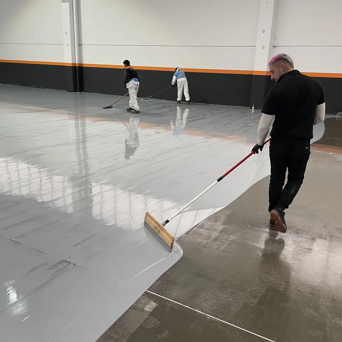 Roller working the junction between coated and primed floor, Galicia Roller working the junction between coated and primed floor, Galicia