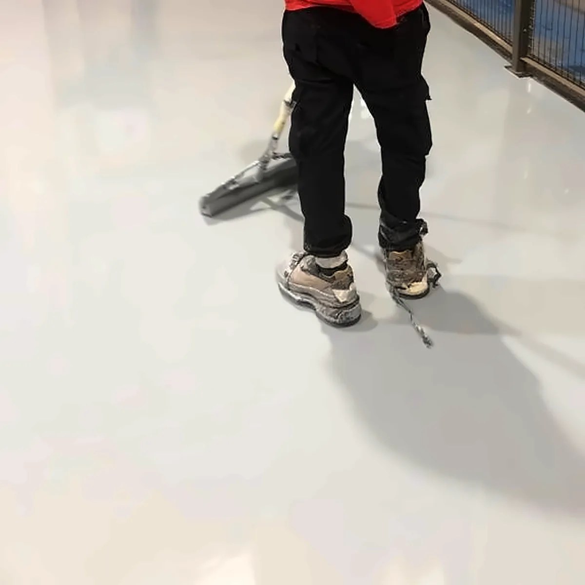 Applicator rolling the grey epoxy finish on the industrial floor in Palma Applicator rolling the grey epoxy finish on the industrial floor in Palma