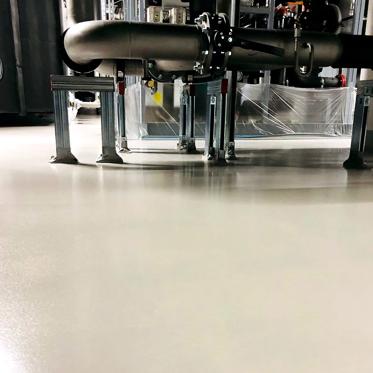 Polyurethane floor running under pipe supports in an industrial kitchen, Germany