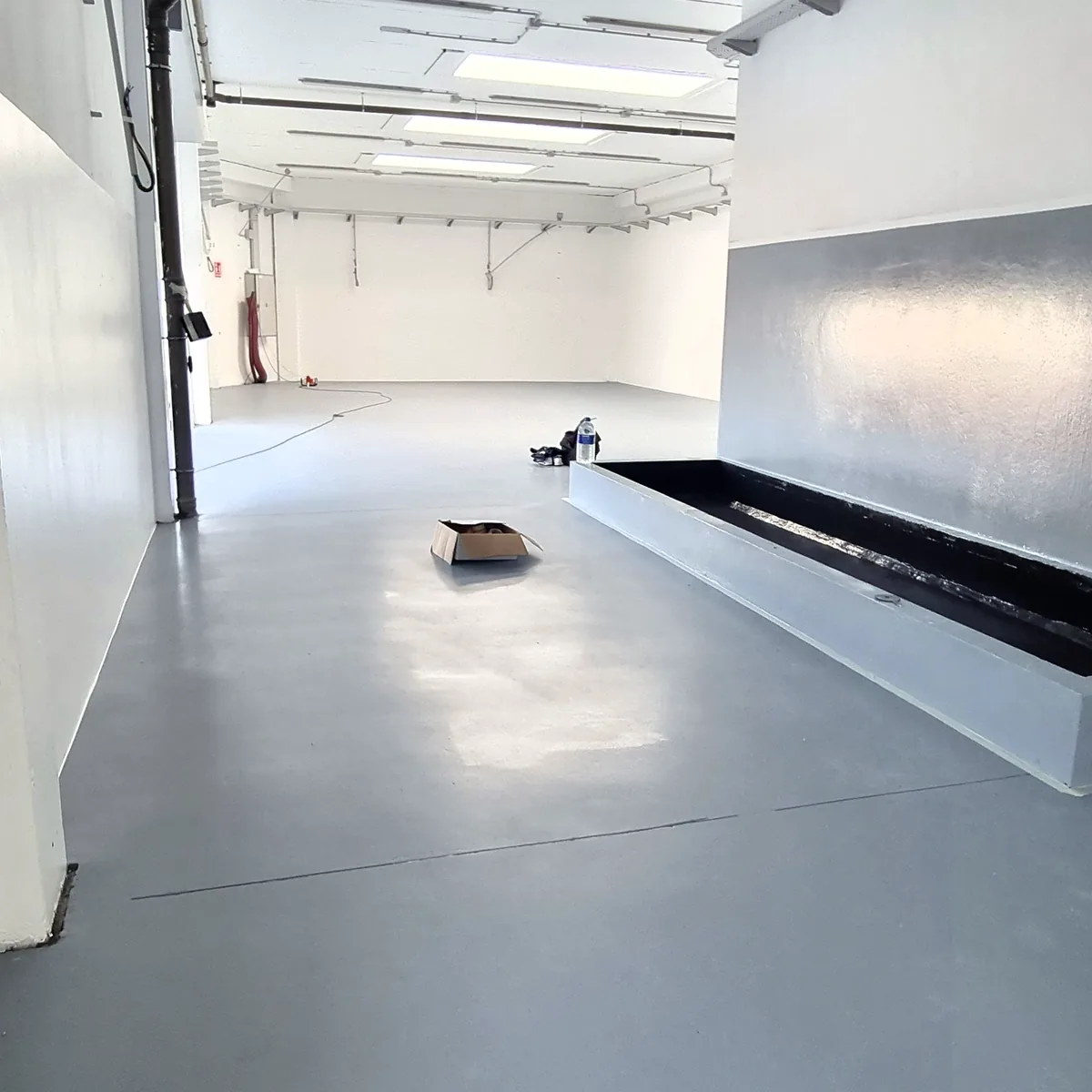 Grey coated dado along the hall wall with the floor below