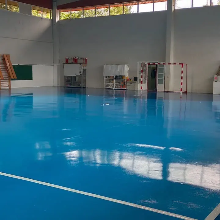 The blue floor toward stacked equipment at the side The blue floor toward stacked equipment at the side