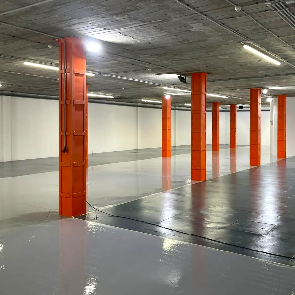 Dark epoxy primer being spread on parking concrete, Palma Dark epoxy primer being spread on parking concrete, Palma