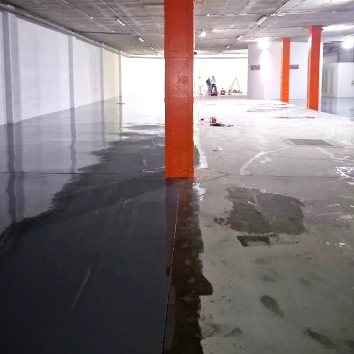 Second wet-edge pass on parking flooring, Palma Second wet-edge pass on parking flooring, Palma