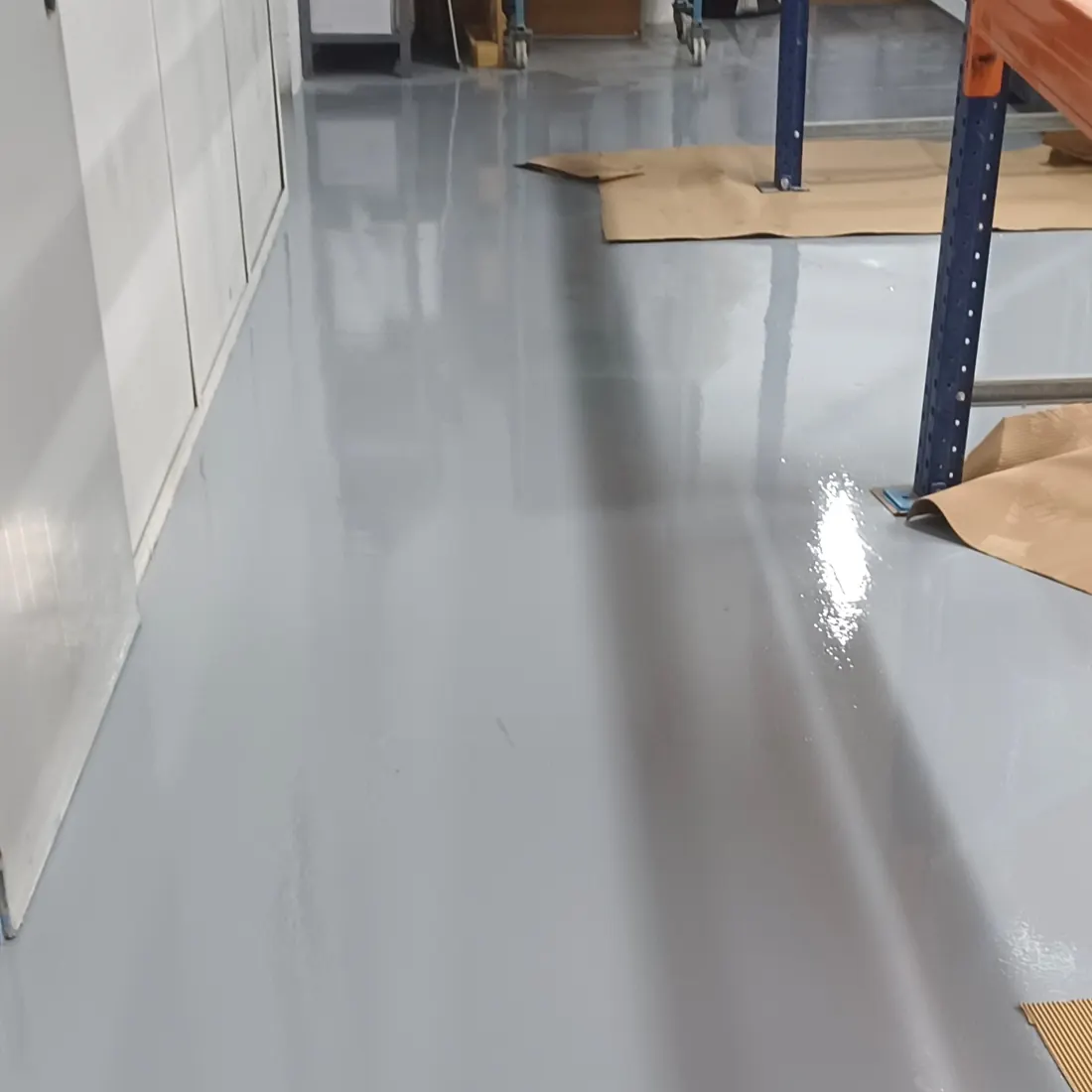 Grey floor along a racking aisle Grey floor along a racking aisle